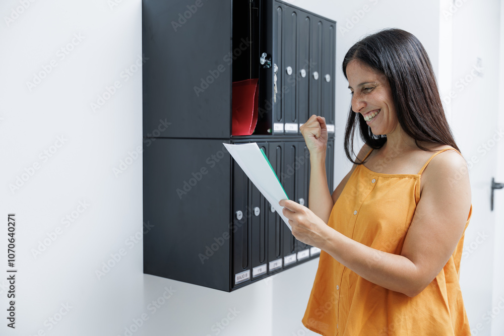 Woman looks at the correspondence in her mailbox and receives the long-awaited notifications, receives good news or from a relative she has not seen for a long time. Woman looks at the correspondence in her mailbox and receives the long-awaited notifications, receives good news or from a relative she has not seen for a long time.
