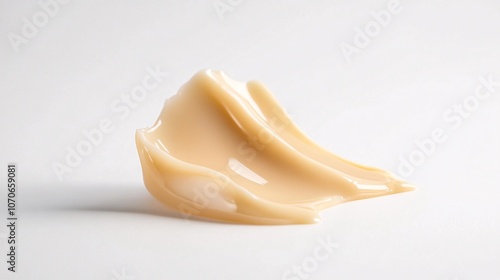 Beige Cosmetic Cream Swirl on White Background