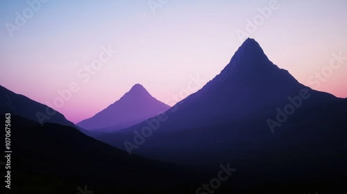 Majestic mountains at dusk, with gentle hues of purple and pink illuminating the skyline.