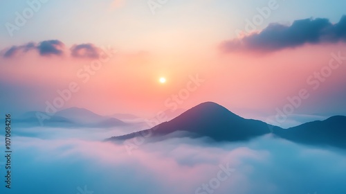 Mountain peak emerging from clouds during a colorful sunset, showcasing serene vistas in a tranquil sky