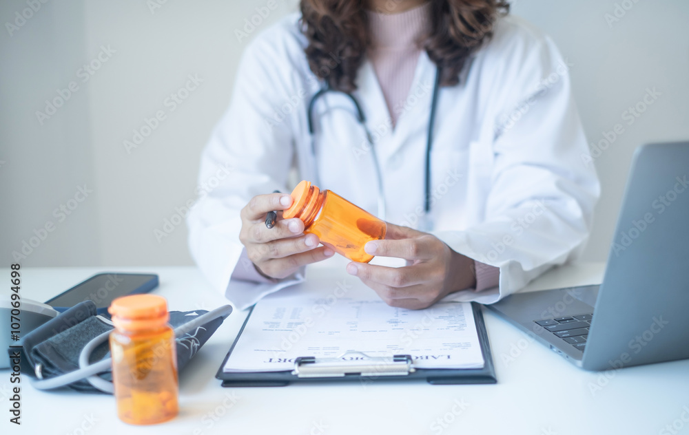 Doctor records the patient's health examination results and medication usage, pill bottle, healthcare, and medical checkup concept Doctor records the patient's health examination results and medication usage, pill bottle, healthcare, and medical checkup concept