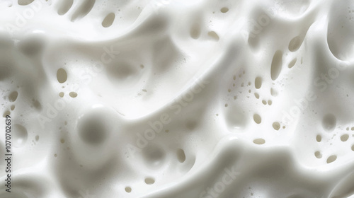 Abstract texture of whipped fresh milk cream, bubbles and milk rivers. Shampoo foam with bubbles. Confectionery or cosmetic banner background.