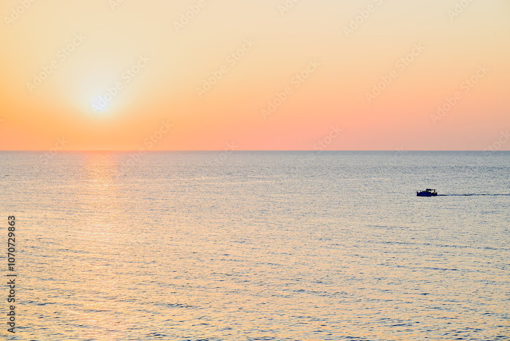 Obraz premium Beautiful sunset with orange sky on the beach of Menorca, Balearic Islands. Sunset, nature