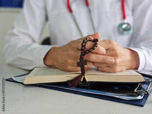 Canvas Print Christian doctor folded hands in prayer with rosary and cross, hoping for the best, providing medical care in hospital clinic