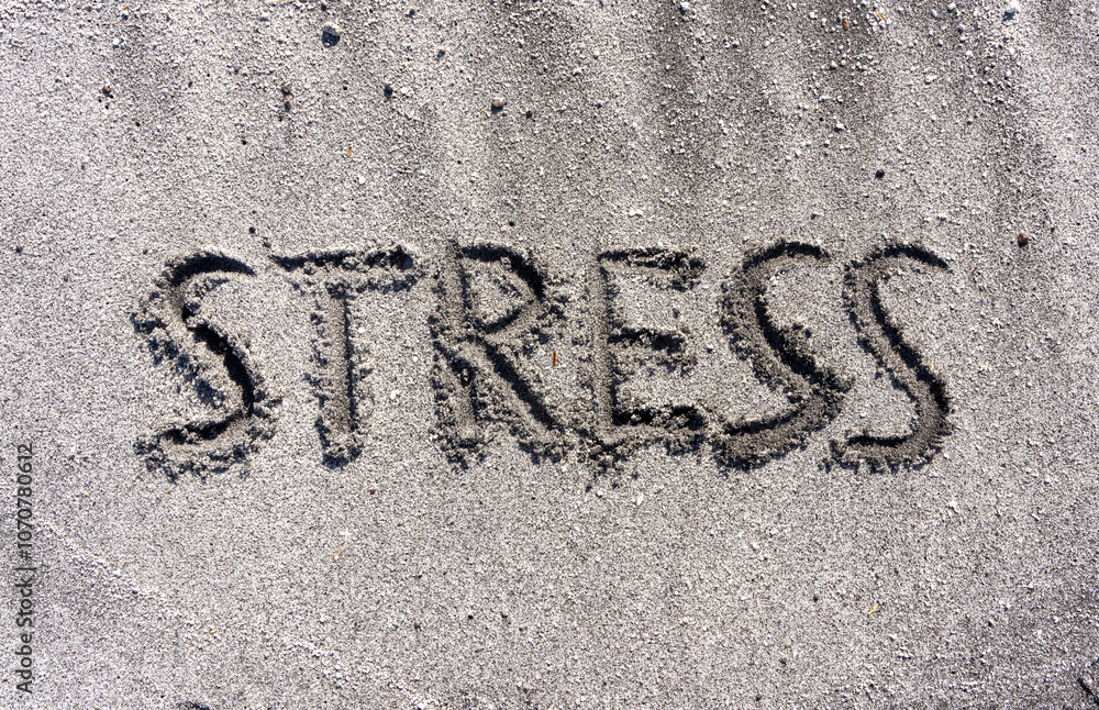 Fototapeta premium lifestyle and stress concept. Concept word Stress written on beautiful ocean sand beach. Beautiful ocean sand beach background, copy space. Medical and psychology stress concept.