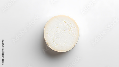 Whole round camembert cheese isolated on white board, top view, with copy space