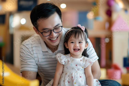 Father and daughter share a joyful moment at an indoor play area filled with colorful toys and cheerful decorations. Generative AI