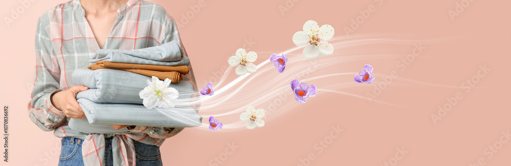 Woman holding stack of clean bed sheets on color background Woman holding stack of clean bed sheets on color background