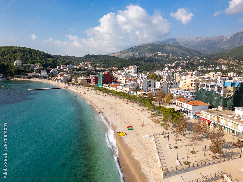 Φωτογραφία Aerial drone photo of boulevard and beach in the coastal town of Himare in Albania