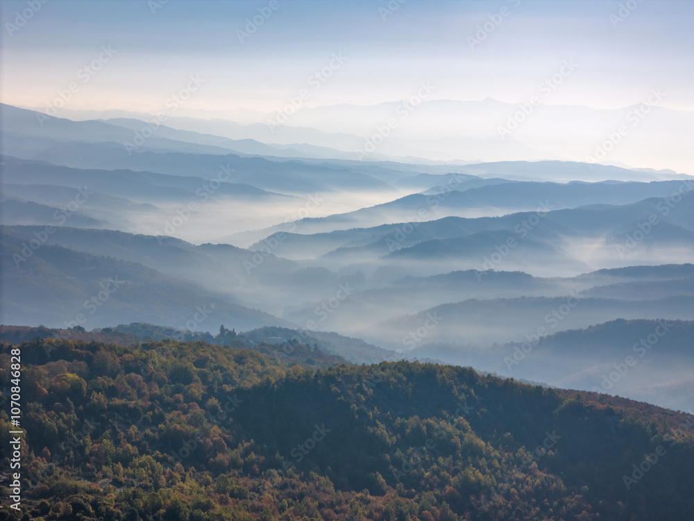 Aerial drone photo of the clouds between the mountains of the Pindos national park in Greece. Aerial drone photo of the clouds between the mountains of the Pindos national park in Greece.