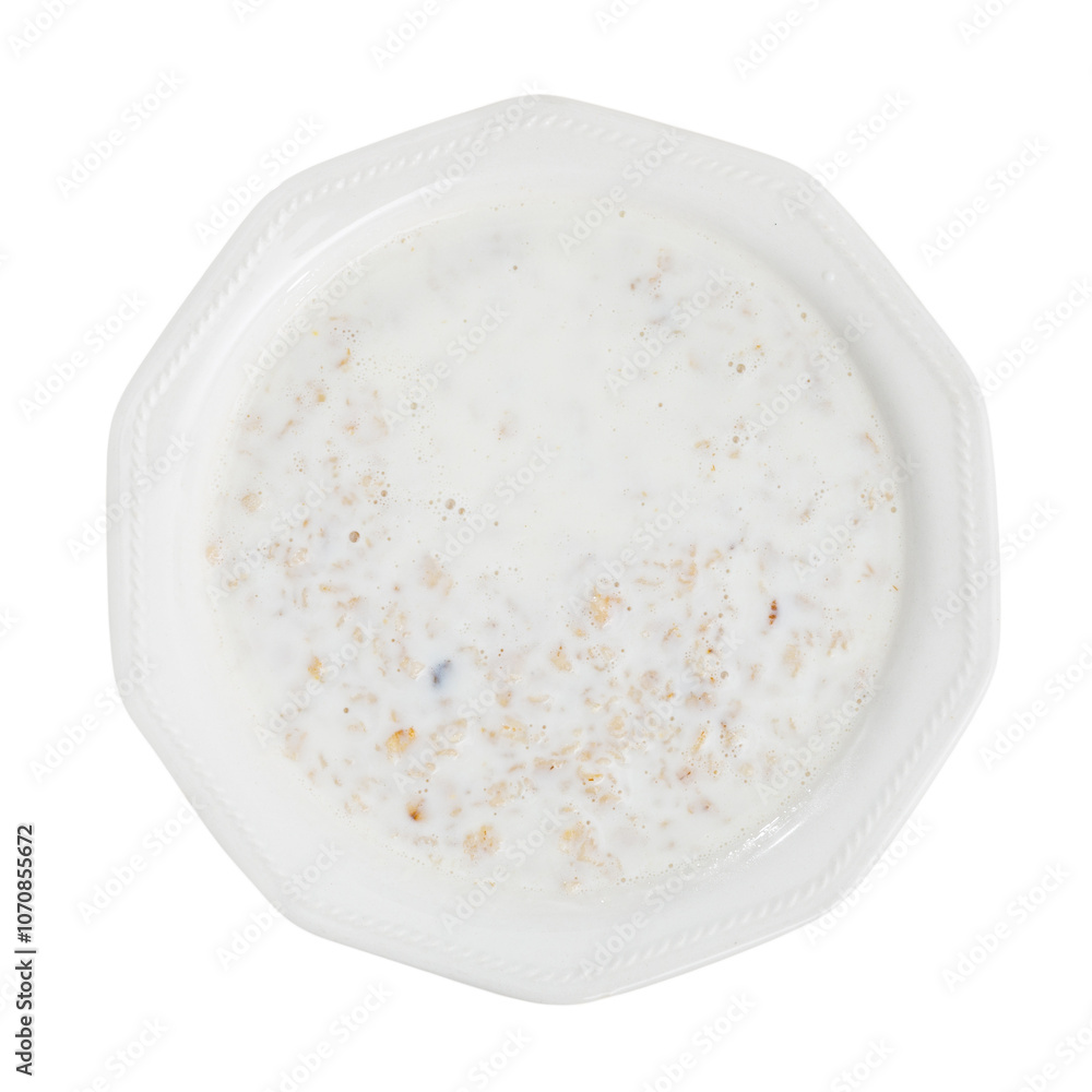 Appetizing milk oatmeal porridge served on plate for breakfast. Isolated over white background