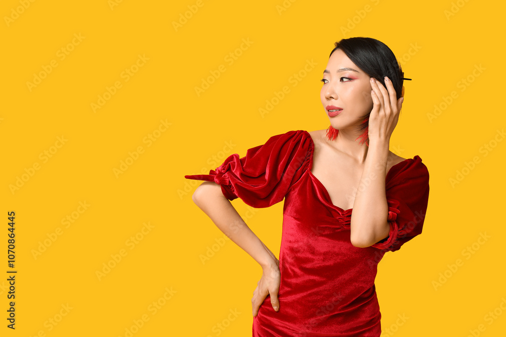 Beautiful young Asian woman on yellow background. Chinese New Year celebration Beautiful young Asian woman on yellow background. Chinese New Year celebration