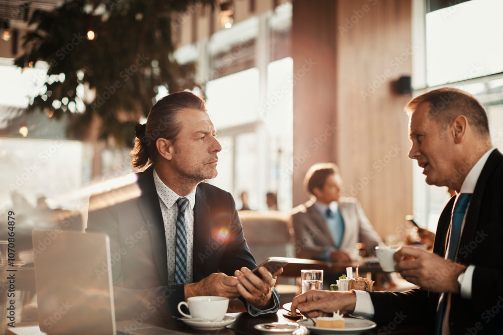 Two businessman having coffee and a meeting in a cafe bar decorated for christmas and the new years holidays Two businessman having coffee and a meeting in a cafe bar decorated for christmas and the new years holidays