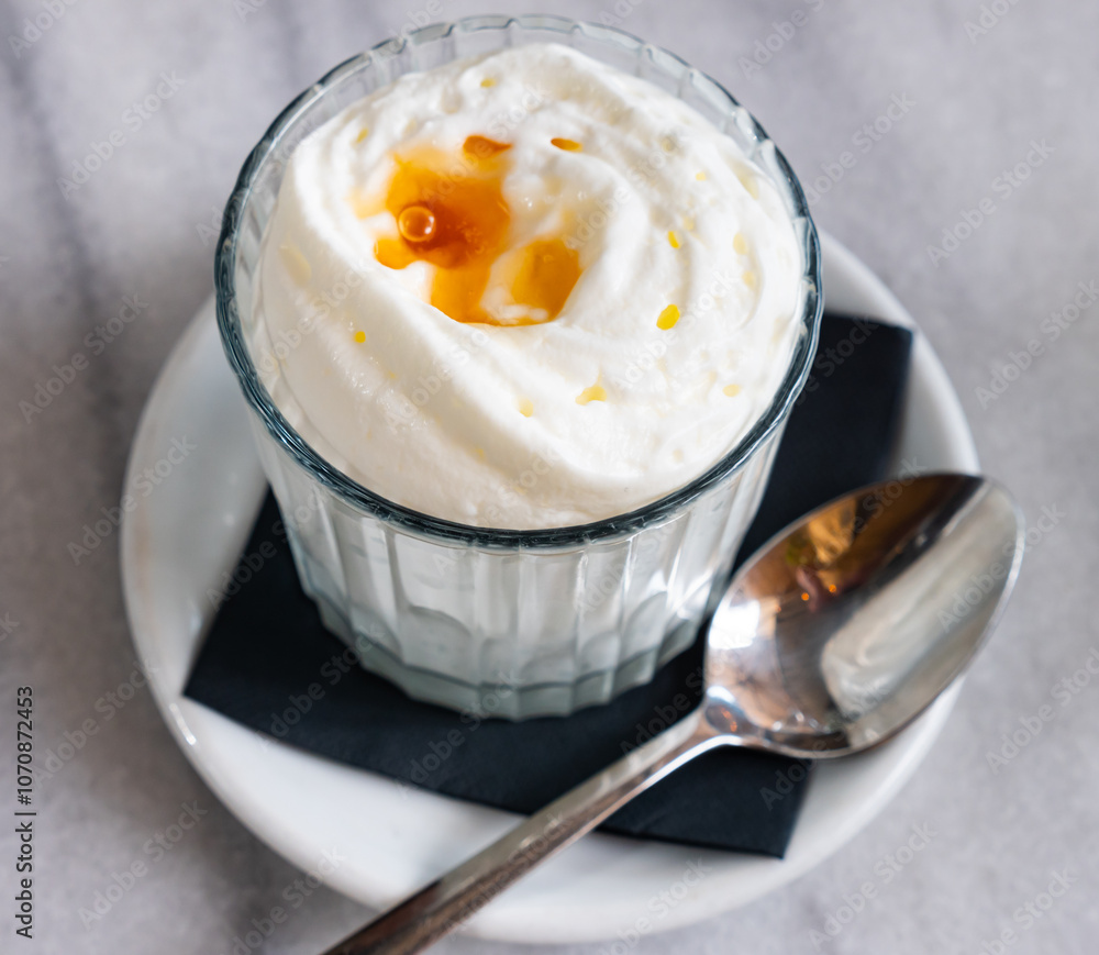 Low-calorie dessert made of yogurt mousse, decorated with liquid transparent honey. Homemade dish, diet menu, ideas of simple desserts for home cooking. Low-calorie dessert made of yogurt mousse, decorated with liquid transparent honey. Homemade dish, diet menu, ideas of simple desserts for home cooking.