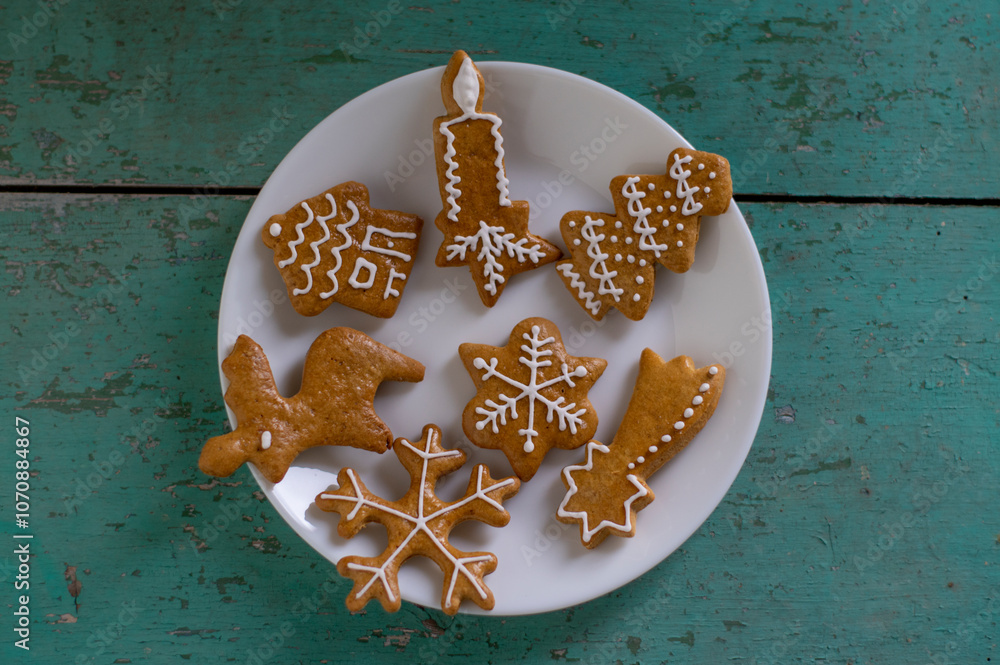 Painted traditional Christmas gingerbreads arranged on old vintage painted table in daylight, common czech tasty sweets