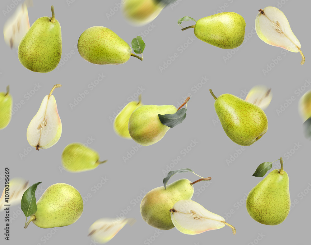 Fresh pears and green leaves in air on grey background Fresh pears and green leaves in air on grey background
