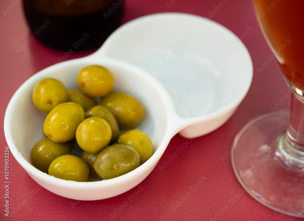 Delicious spanish tapas from marinaded green olives at plate