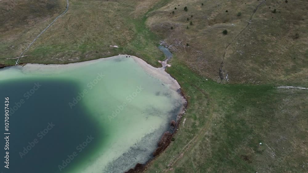Vrazje jezero - Devils Lake- a glacial reservoir in Durmitor National Park, Montenegro country. Aerial top view from drone. Calm autumn landscape scene Vrazje jezero - Devils Lake- a glacial reservoir in Durmitor National Park, Montenegro country. Aerial top view from drone. Calm autumn landscape scene