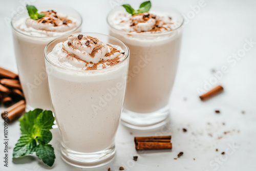 Delicious creamy drinks topped with whipped cream and a sprinkle of chocolate and cinnamon on a bright surface. Generative AI