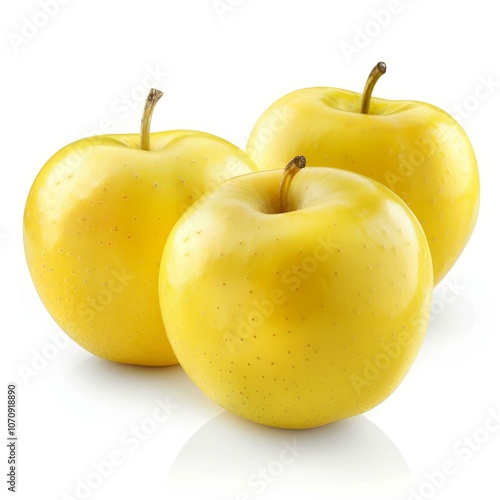 Three whole yellow apples with stems are sitting on a bright white surface