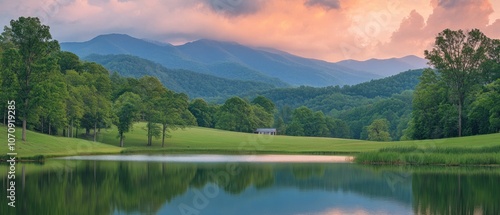 Serene landscape with mountains, a calm lake, and a rustic building under a colorful sky.