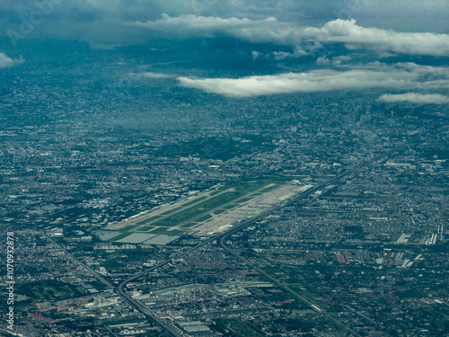 aerial landscape view of area around Don Mueang International Airport in Bangkok, Thailand with runways, taxiways, apron and terminal buildings  photo