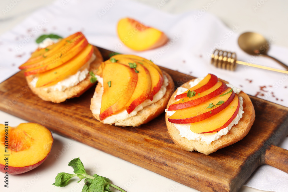 Wooden board of peach bruschetta with ricotta and mint on white background, closeup Wooden board of peach bruschetta with ricotta and mint on white background, closeup