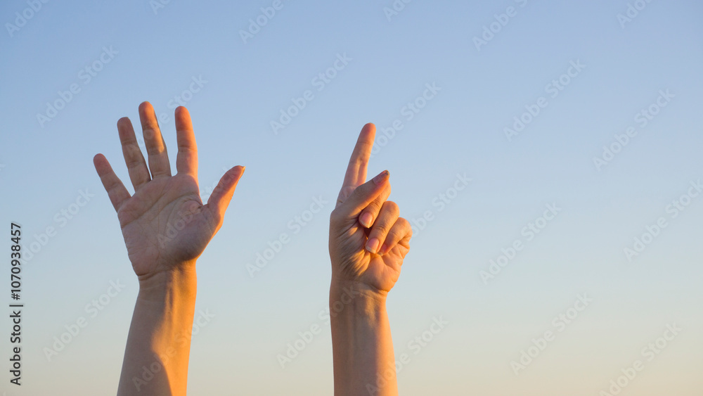Woman hands showing or doing number six gesture on blue summer sky background. Counting down, six fingers up concept idea. Woman hands showing or doing number six gesture on blue summer sky background. Counting down, six fingers up concept idea.
