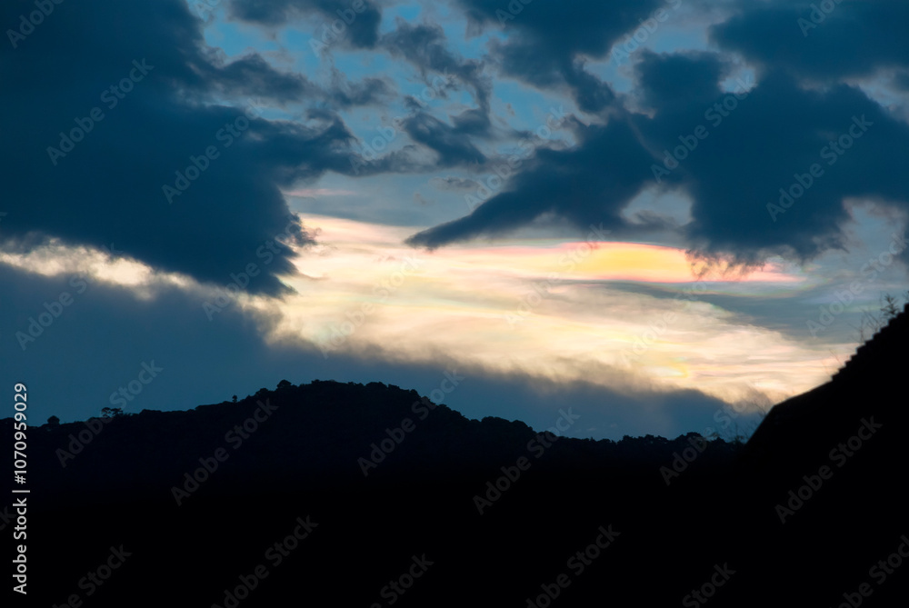 Silhouette of mountains with multi-color lenticular clouds in rural area of Guatemala, city of Latin America, sunset landscape. Silhouette of mountains with multi-color lenticular clouds in rural area of Guatemala, city of Latin America, sunset landscape.