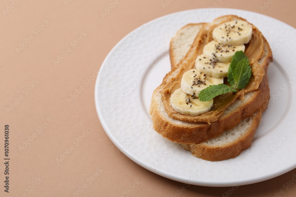 Tasty sandwich with peanut butter, banana, chia seeds and mint on brown background, closeup. Space for text Tasty sandwich with peanut butter, banana, chia seeds and mint on brown background, closeup. Space for text