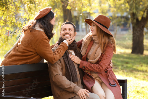 Man with two beautiful wome...