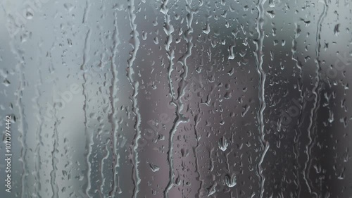 Raindrops Falling on Wet Window in Rainy Weather
