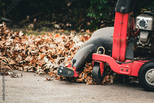 retro close-up of a chipper shredder vac on fall foliage autumn leaves landscaping background photo