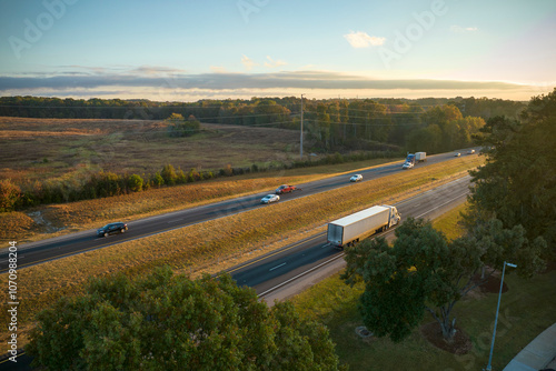 View from above of busy american highway with fast moving trucks and cars. Interstate transportation concept