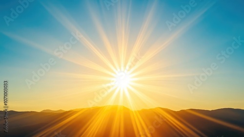 Bright Sunrise Over Mountain Landscape with Radiating Sunbeams