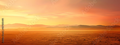 A breathtaking sunset over a vast desert landscape, showcasing warm hues of orange and pink blending into the horizon.