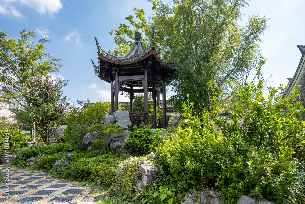A serene Chinese garden with a traditional wooden pavilion or Asian gazebo, surrounded by lush greenery and picturesque rock formations. A rest area or shelter in an oriental public park. A serene Chinese garden with a traditional wooden pavilion or Asian gazebo, surrounded by lush greenery and picturesque rock formations. A rest area or shelter in an oriental public park.