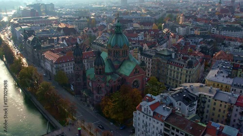 4K Aerial Drone video of beautiful autumn in city center Munich with Isar river, Saint Lukas church, Marienplatz and Maximilianeum on a sunny warm day, Germany