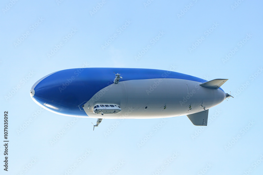 Obraz premium A tourist airship with passengers on board travels through the sky.