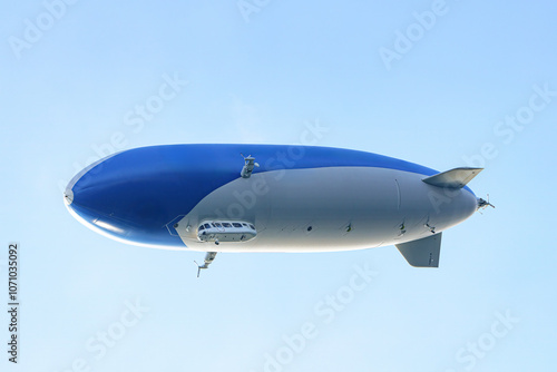 A tourist airship with passengers on board travels through the sky.