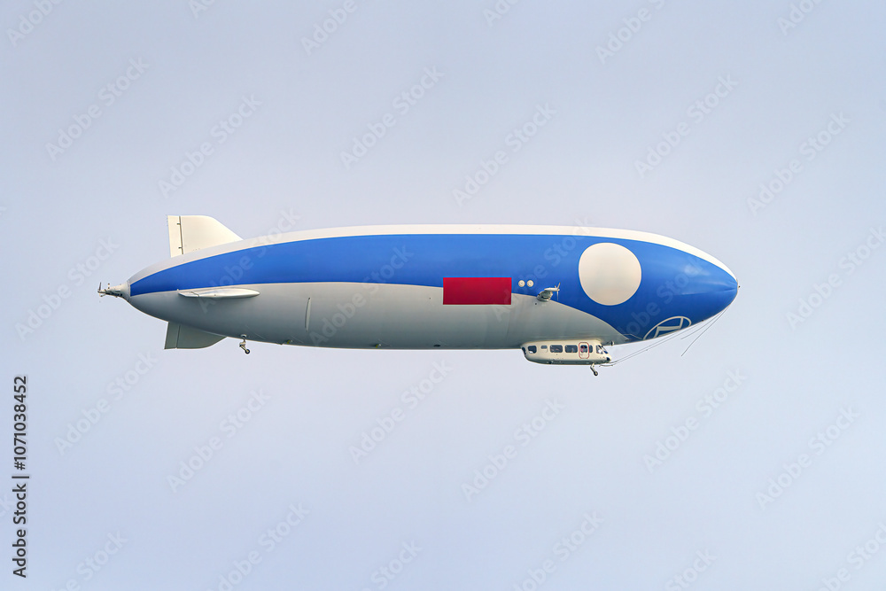 An airship in the sky with people on an excursion above the earth in a tourist flight. An airship in the sky with people on an excursion above the earth in a tourist flight.