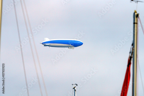 A tourist airship with passengers on board travels through the sky.