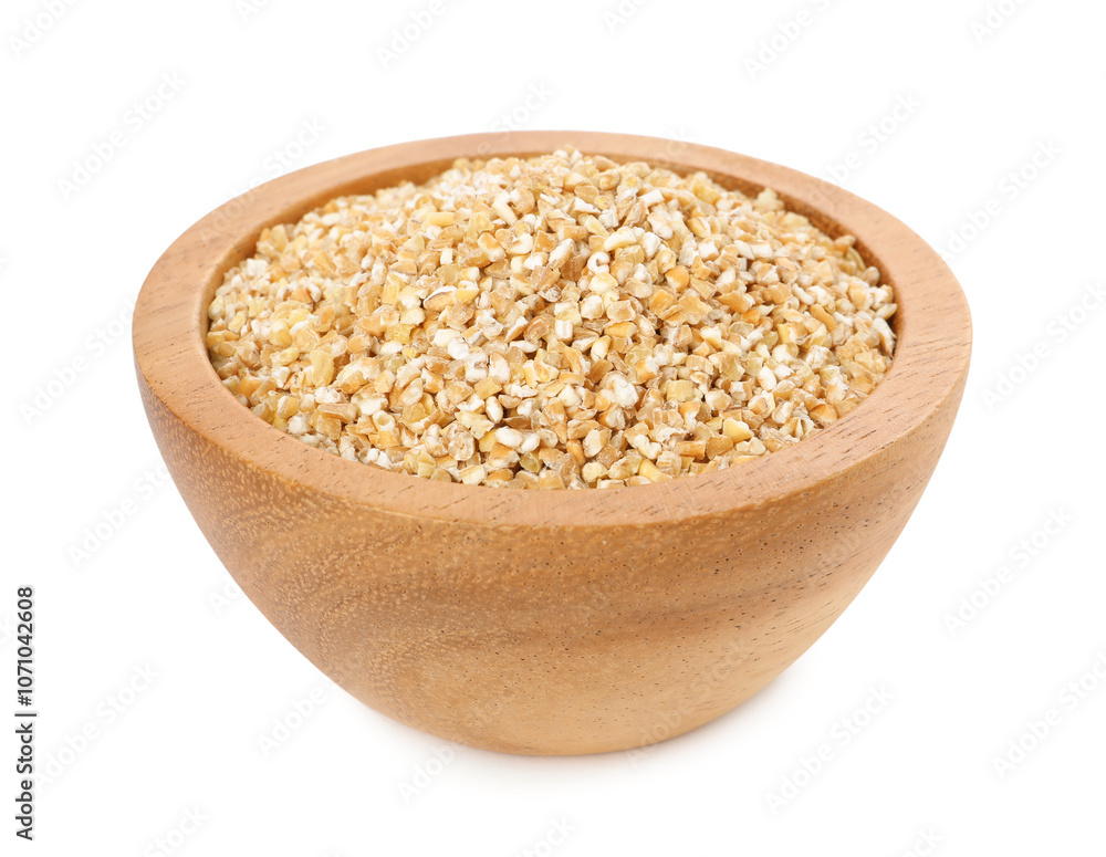 Dry wheat groats in wooden bowl isolated on white Dry wheat groats in wooden bowl isolated on white