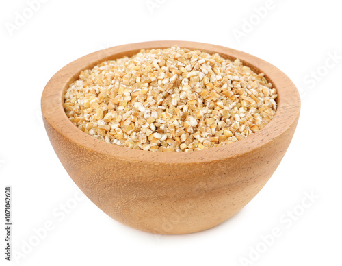 Dry wheat groats in wooden bowl isolated on white