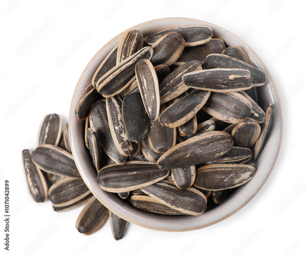 Sunflower seeds in bowl isolated on white, top view Sunflower seeds in bowl isolated on white, top view