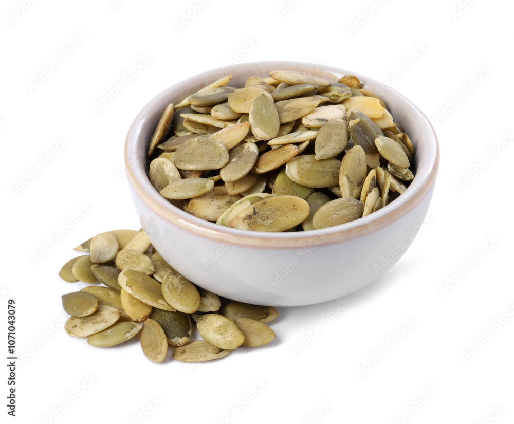 Peeled pumpkin seeds in bowl isolated on white Peeled pumpkin seeds in bowl isolated on white