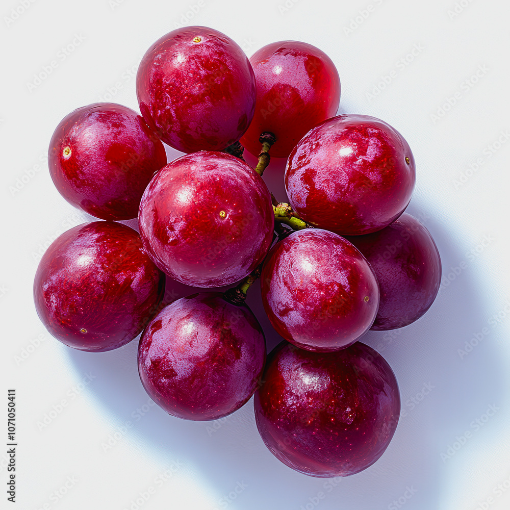 A vibrant cluster of fresh red grapes on a minimalist white background. Perfect for culinary, nutrition, and healthy lifestyle themes in stock photography. A vibrant cluster of fresh red grapes on a minimalist white background. Perfect for culinary, nutrition, and healthy lifestyle themes in stock photography.