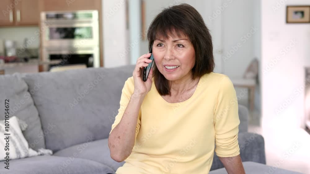 Attractive woman enjoying talking using internet smartphone technology relaxing sitting on home sofa. Attractive woman enjoying talking using internet smartphone technology relaxing sitting on home sofa.