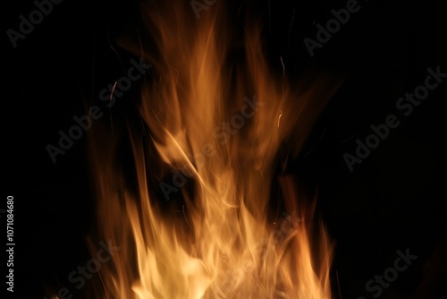 Bright golden orange flames against black background with copy space