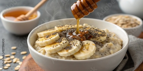 FiberRich Breakfast A closeup of a bowl of oatmeal topped with sliced banana chia seeds and a drizzle of honey. This image captures a nutritious breakfast rich in fiber that keeps